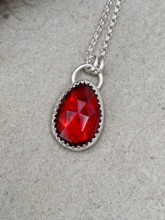 small freeform rosecut garnet hung from oversized bail on a dainty rolo chain