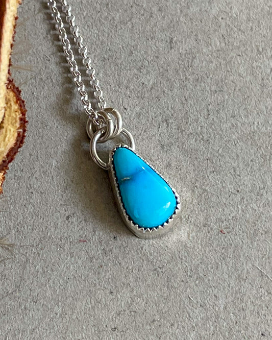 handcrafted sonoran rose turquoise necklace set in serrated bezel hung from double jump rings on dainty rolo chain