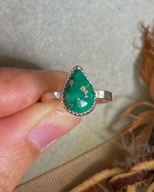 emerald valley pear ring handcrafted in serrated bezel on a flat band