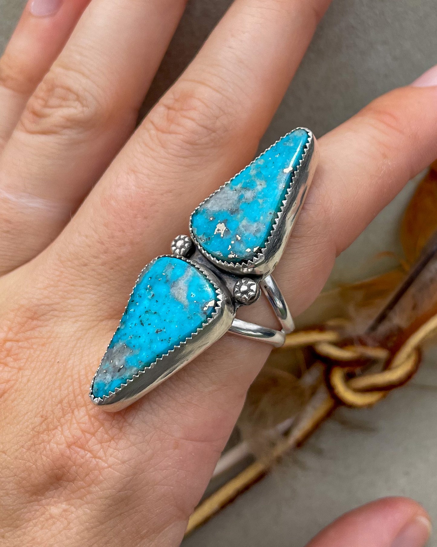 handcrafted ithica peak turquoise double triangular stone ring with natural pyrite set in serrated bezels with floral beads on a split shank band