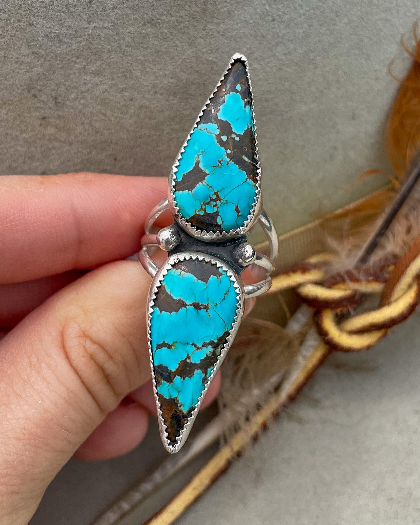 handcrafted #8 turquoise double teardrop ring with ends together and hand-forged accent beads separating the stones all on a triple split shank