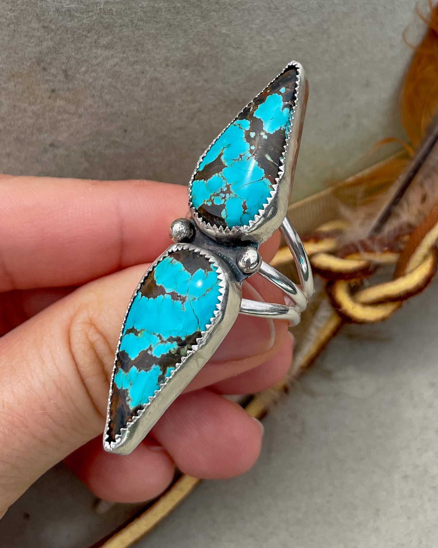 handcrafted #8 turquoise double teardrop ring with ends together and hand-forged accent beads separating the stones all on a triple split shank