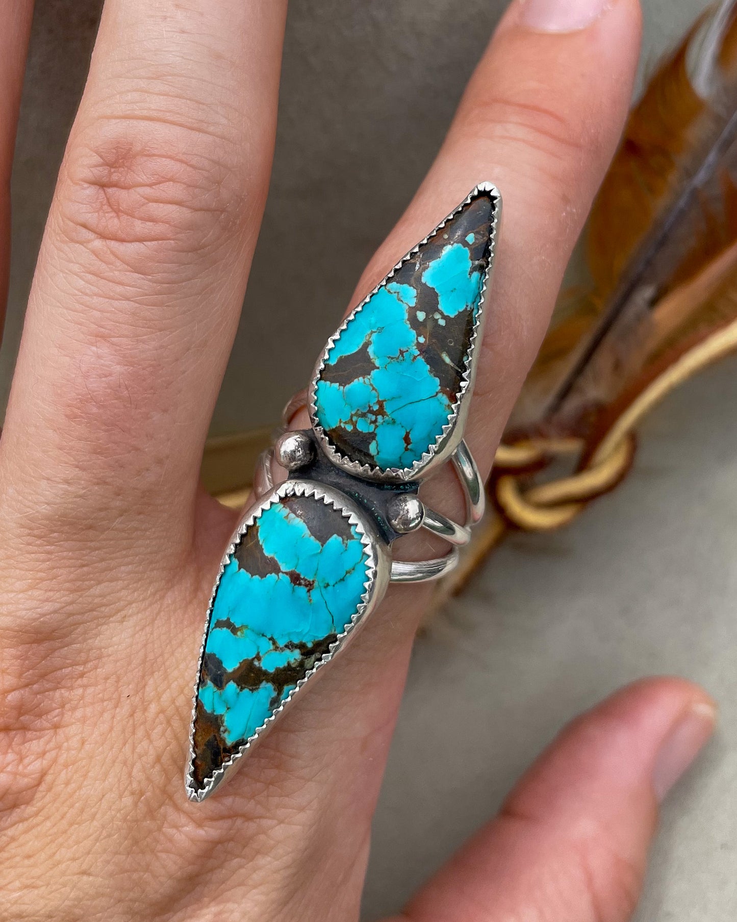 handcrafted #8 turquoise double teardrop ring with ends together and hand-forged accent beads separating the stones all on a triple split shank