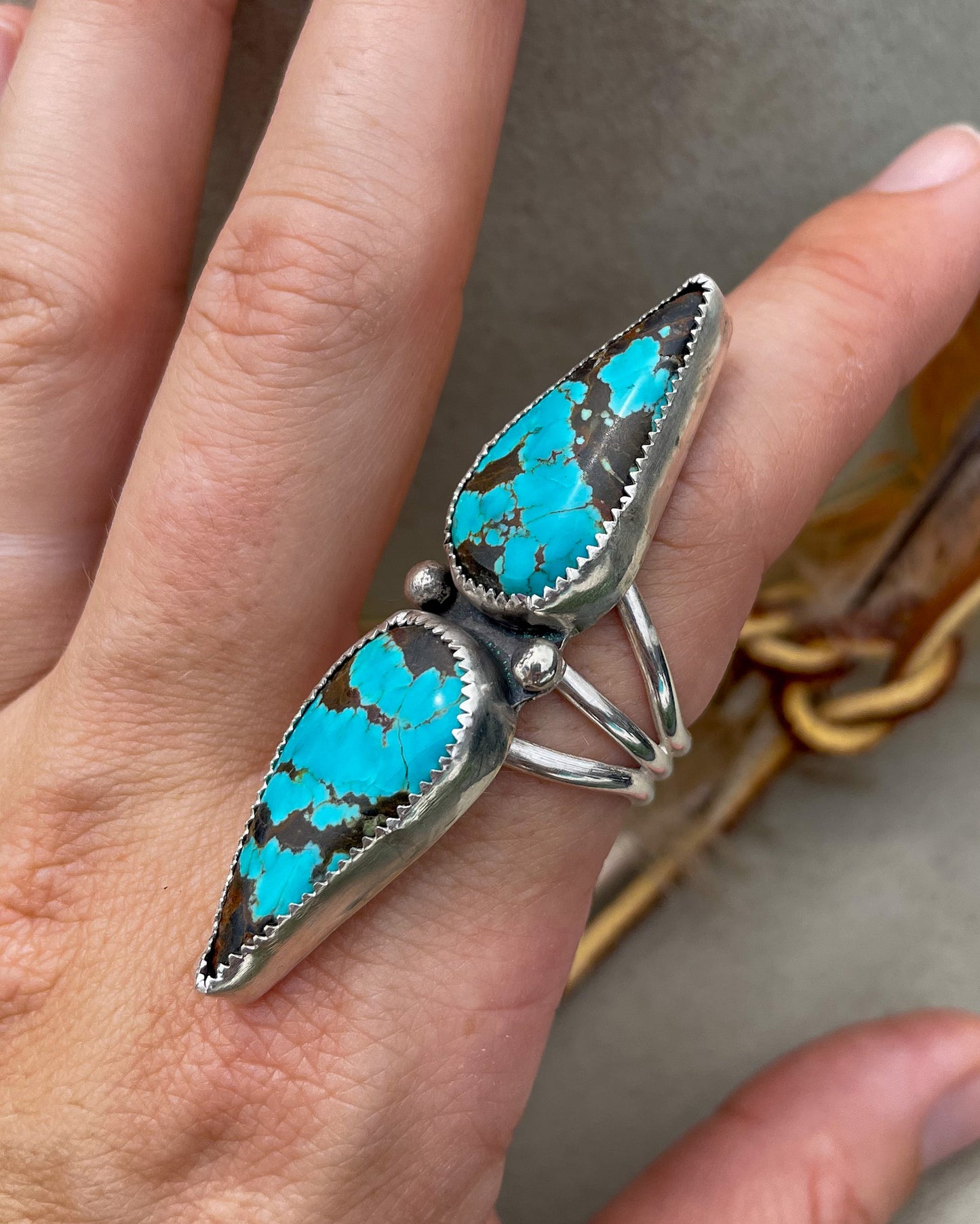 handcrafted #8 turquoise double teardrop ring with ends together and hand-forged accent beads separating the stones all on a triple split shank