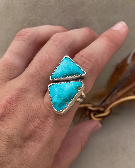 two triangular sierra bella turquoise stones in one striking geometric ring set in serrated bezels on a sterling silver split shank band