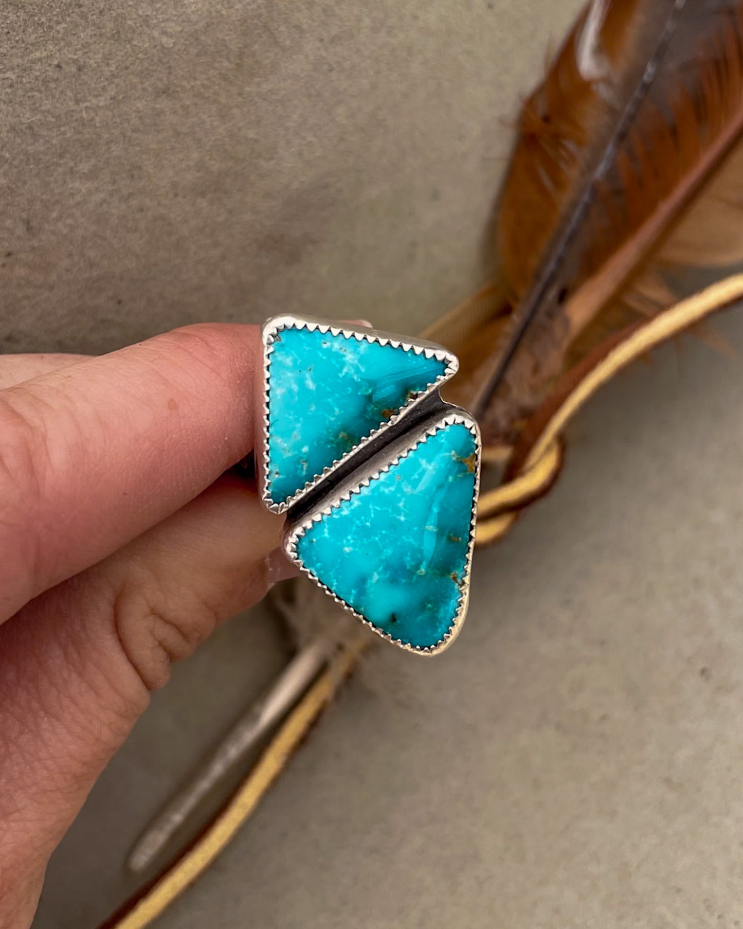 two triangular sierra bella turquoise stones in one striking geometric ring set in serrated bezels on a sterling silver split shank band