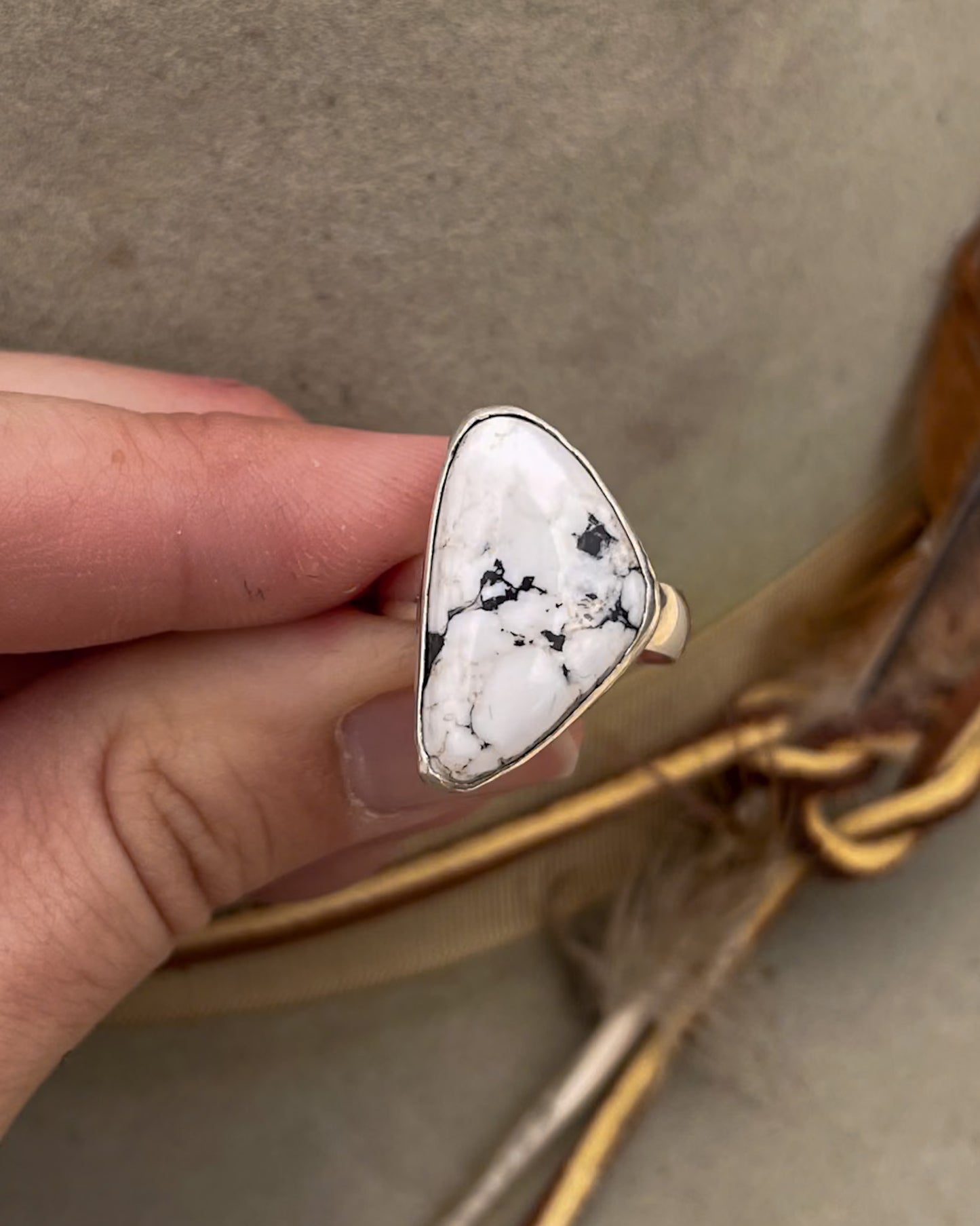 white buffalo triangular stone ring with smooth bezel on chunky silver band