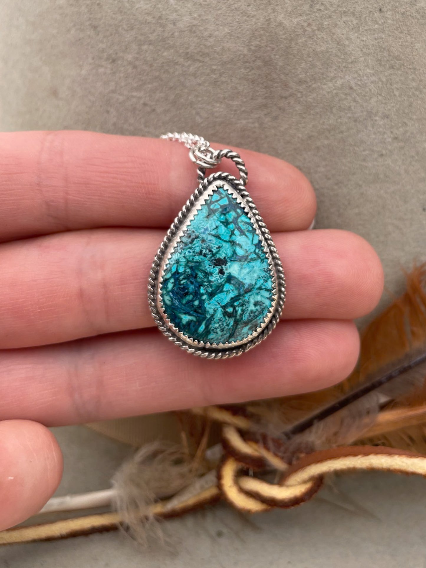 teardop shaped chrysocolla pendant with twist rope border on dainty rolo chain