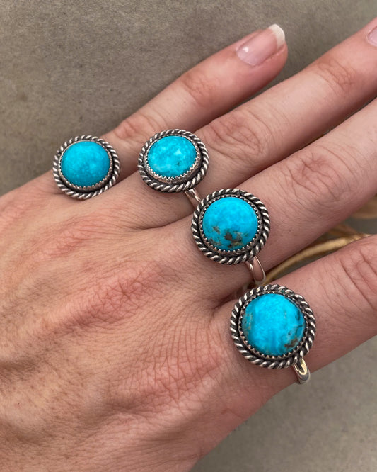 four round kingman turquoise rings with twist rope border on silver halfround band