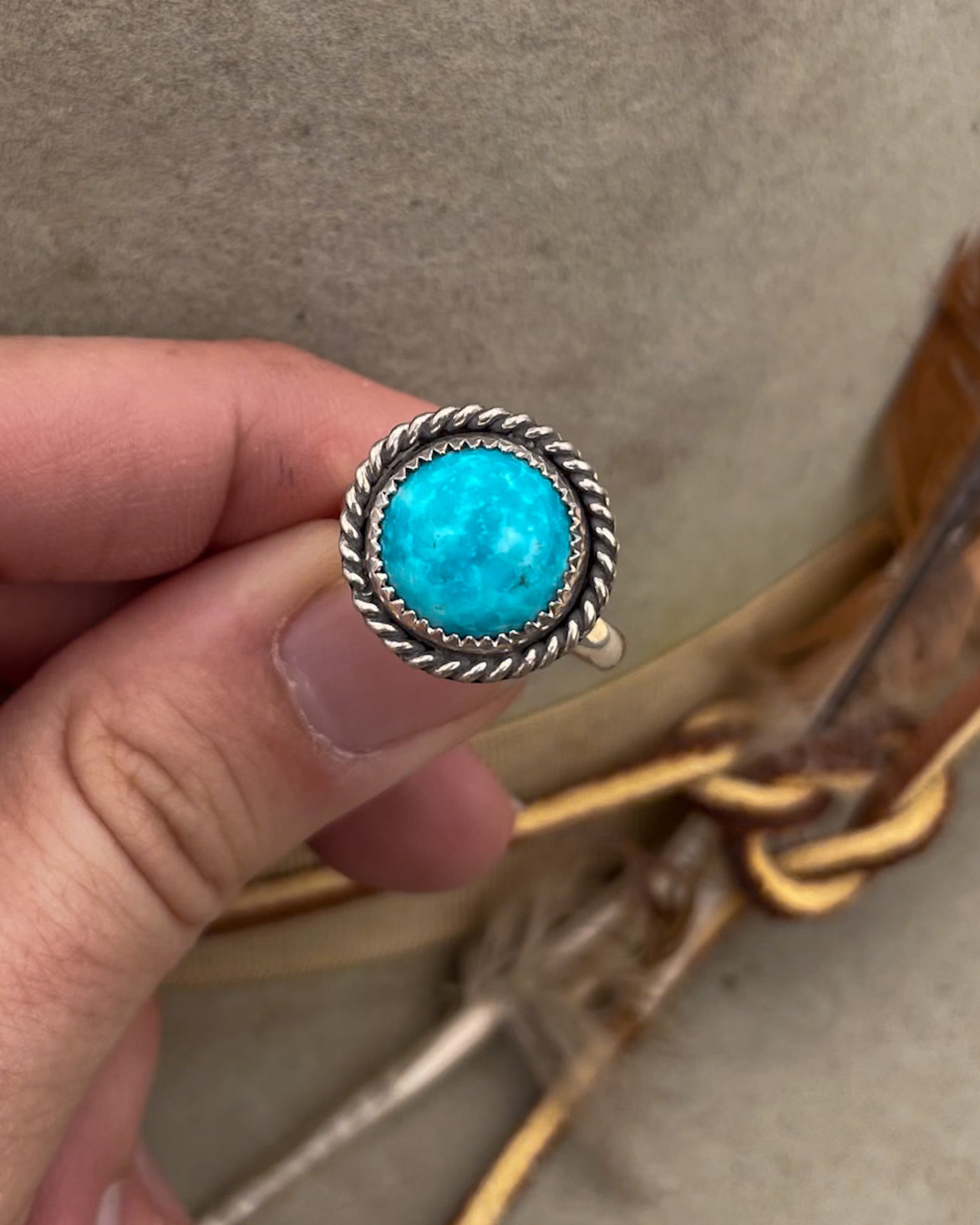 round kingman turquoise ring with twist rope border on silver halfround band