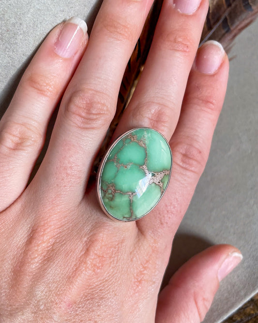 Large oval mint green turquoise ring on hand