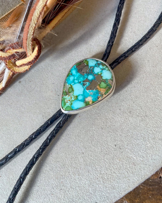 sonoran gold turquoise bolo set in smooth bezel on black breaded cord