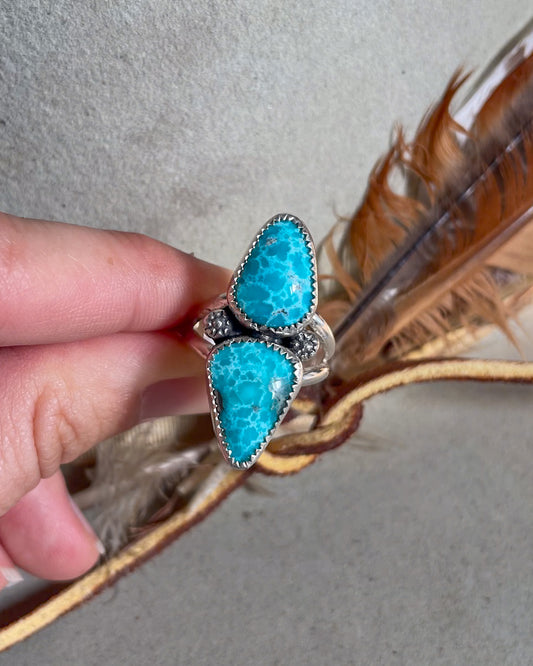 two stone white water turquoise ring with floral accents on split shank