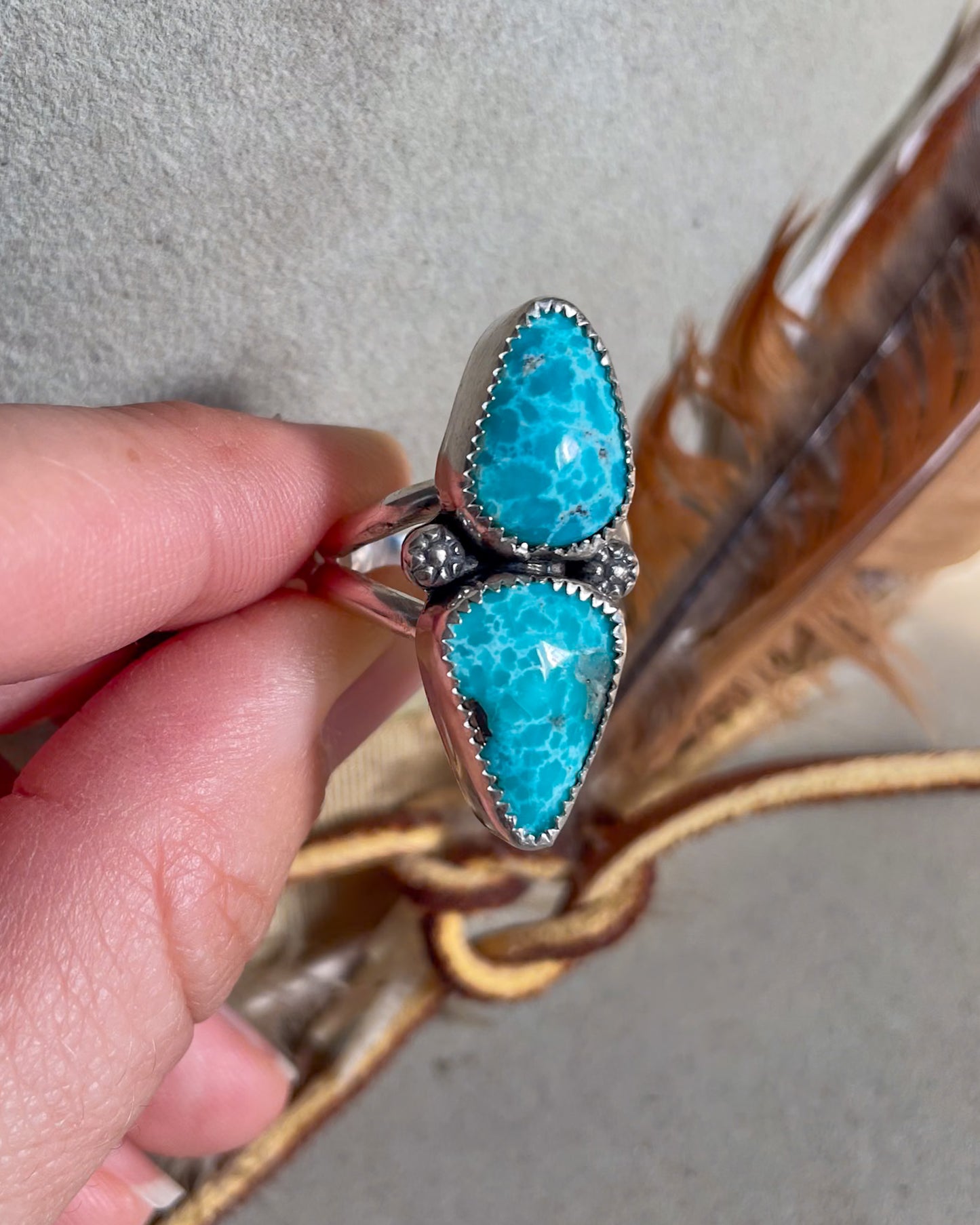 modern turquoise two stone ring with flower accents on split shank band