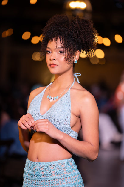 woman wearing light blue top with white buffalo and sleeping beauty turquoise necklace and sleeping beauty earrings