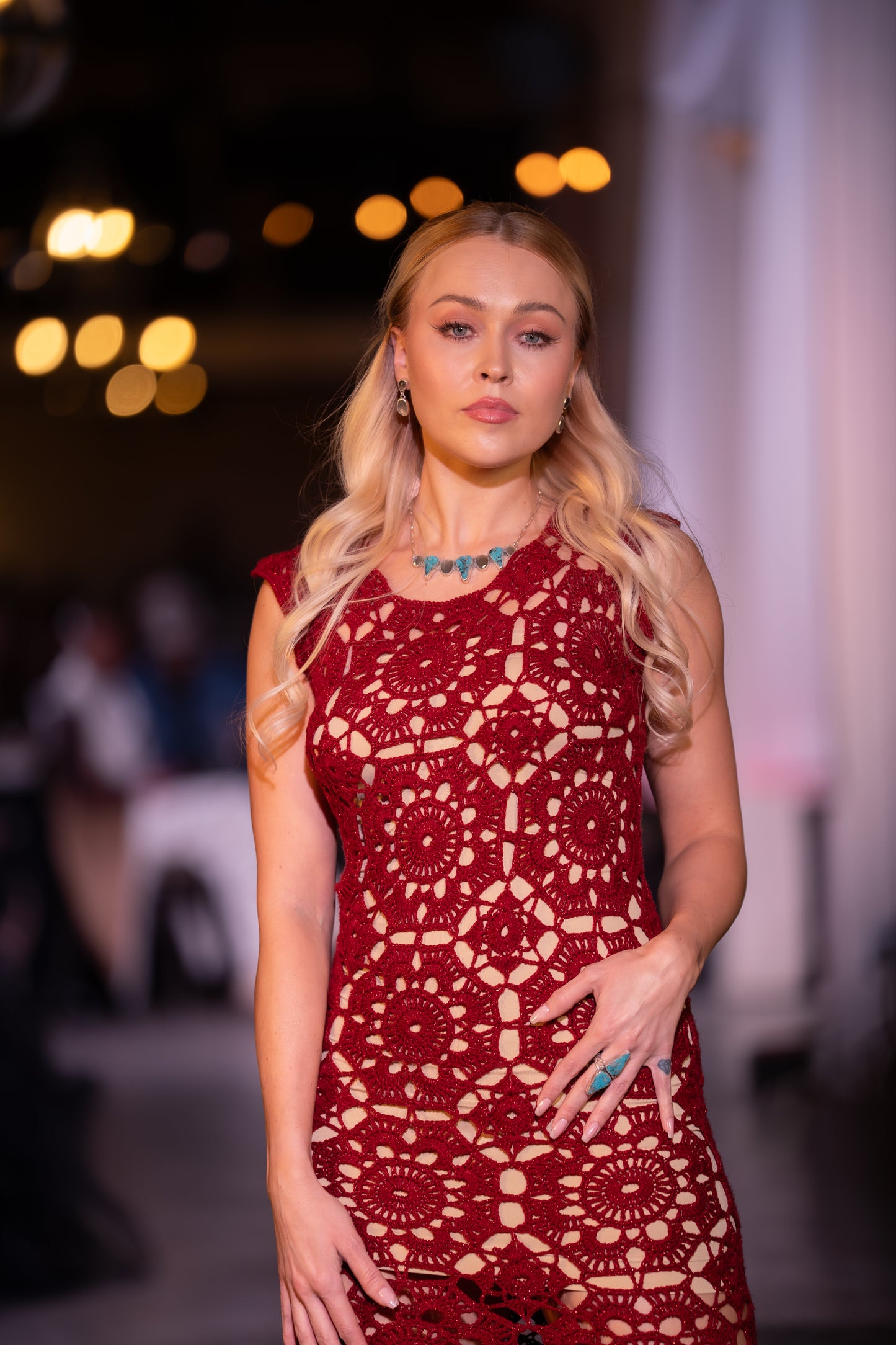 woman wearing red dress and ithaca peak turquoise and grey moonstone necklace with matching two stone turquoise ring and grey moonstone earrings on runway