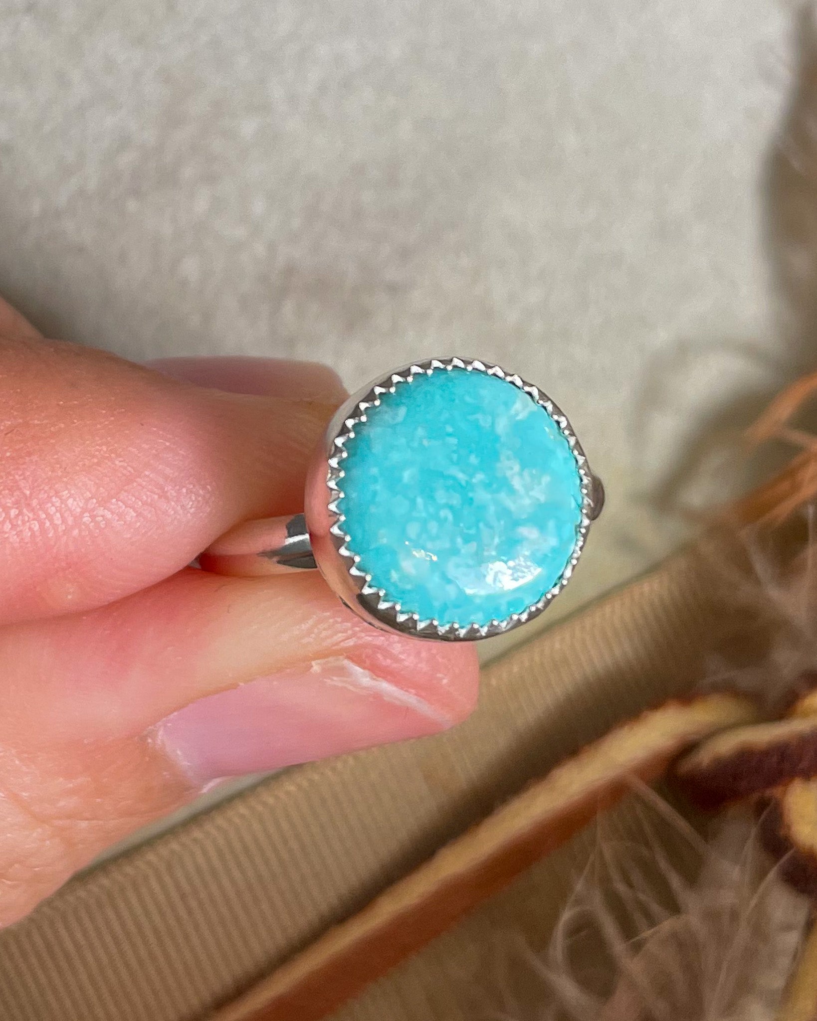 round white water turquoise ring handcrafted in serrated bezel on a half round band