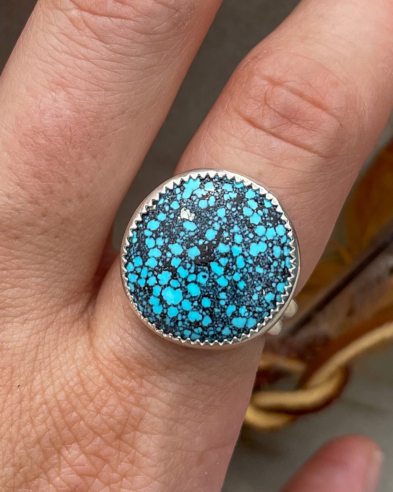 medium sized handmade natural spiderweb kingman turquoise round ring with natural pyrite fleck in a serrated bezel on a double half round band