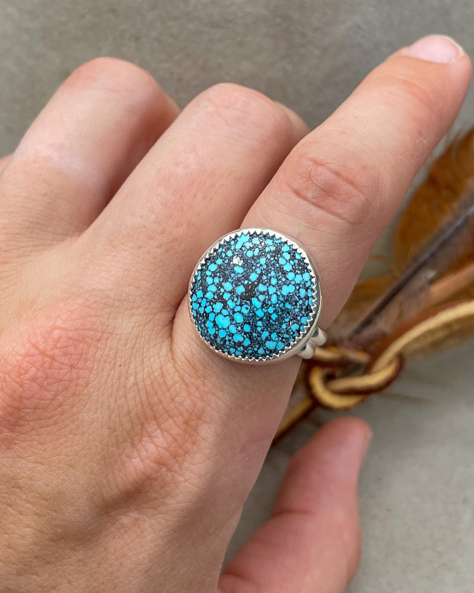 medium sized handmade natural spiderweb kingman turquoise round ring with natural pyrite fleck in a serrated bezel on a double half round band