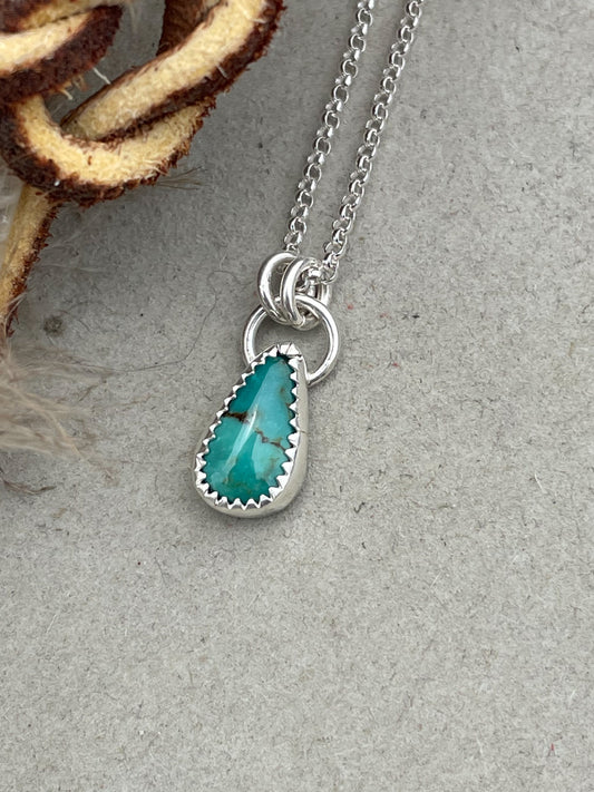 dainty dark seafoam teal carico lake turquoise necklace set in serrated bezel hung from double jump rings on dainty rolo chain
