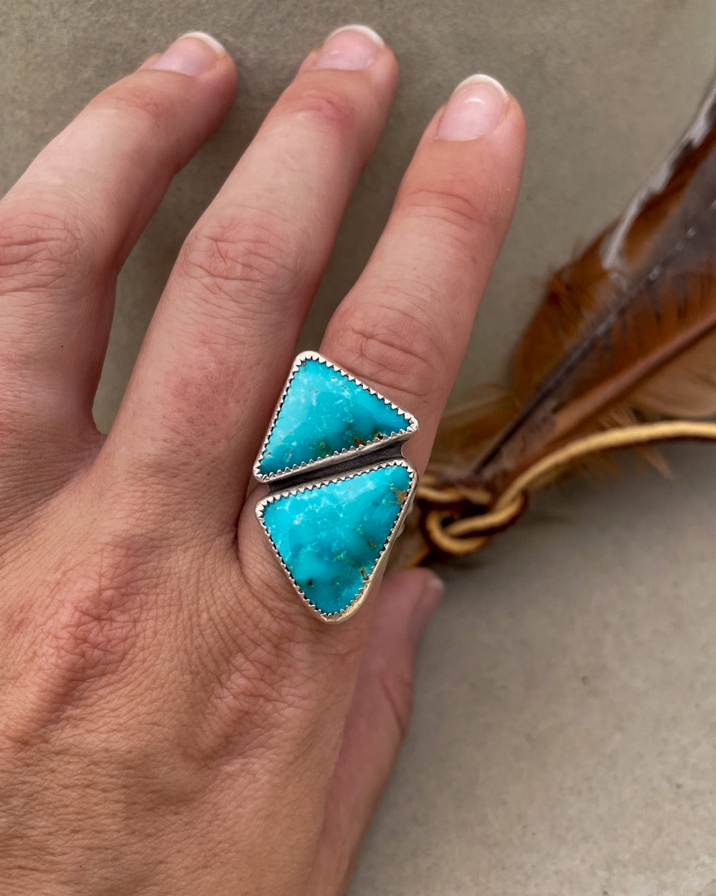 two triangular sierra bella turquoise stones in one striking geometric ring set in serrated bezels on a sterling silver split shank band