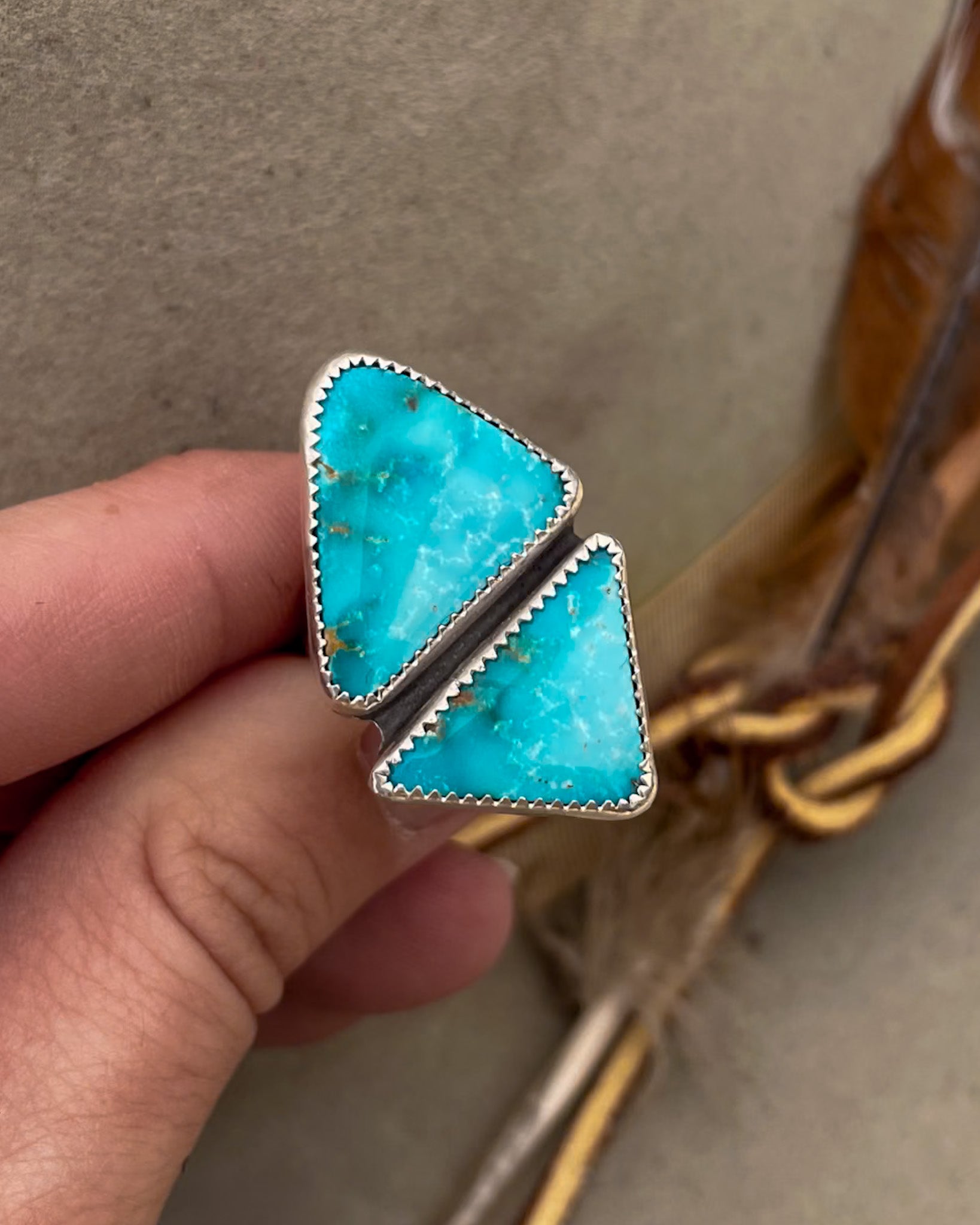 two triangular sierra bella turquoise stones in one striking geometric ring set in serrated bezels on a sterling silver split shank band