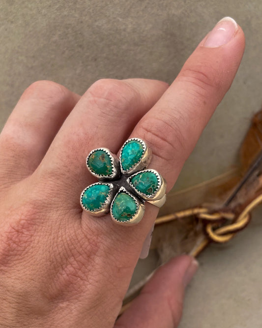 green emerald valley turquoise flower shaped ring in serrated bezels on chunky silver band