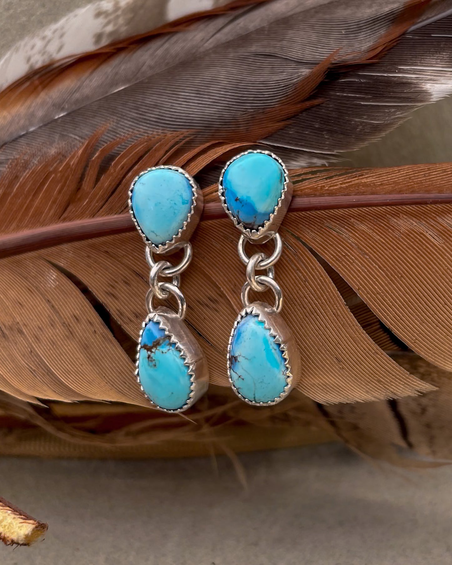 golden hill turquoise earrings with pear shaped stud and pear dangle hanging from the point