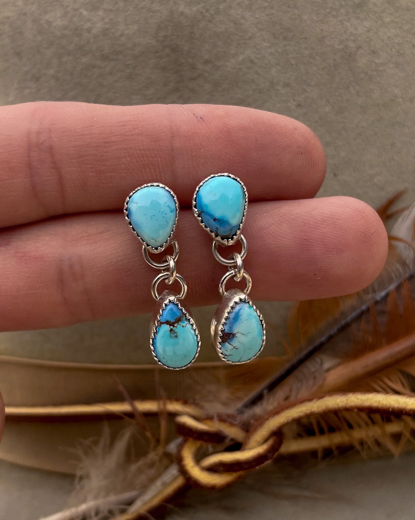 golden hill turquoise earrings with pear shaped stud and pear dangle hanging from the point