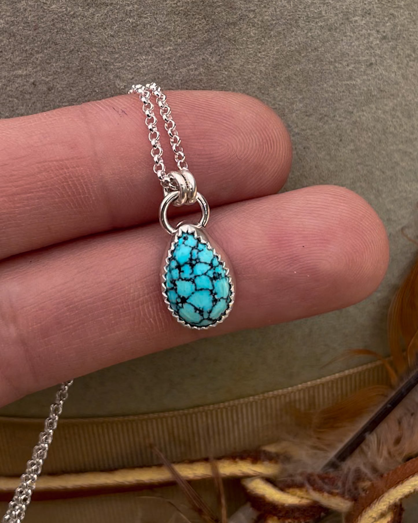 small spiderweb kingman turquoise teardrop pendant on dainty rolo chain