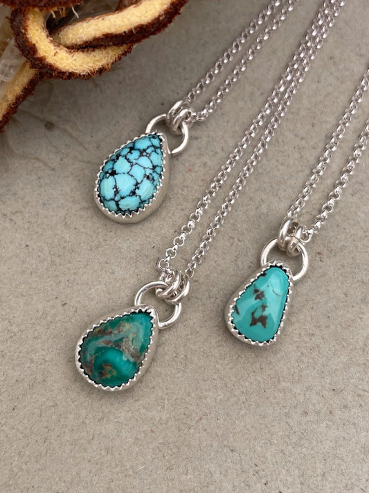 three small turquoise teardrop pendants on dainty rolo chains