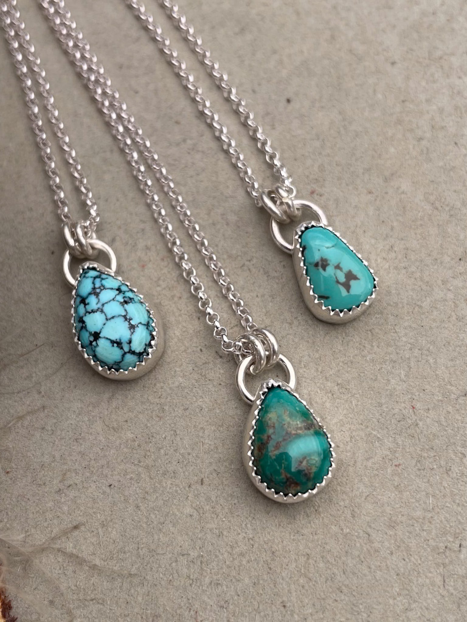 three small turquoise teardrop pendants on dainty rolo chains