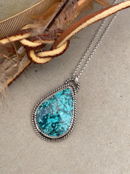 teardop shaped chrysocolla pendant with twist rope border on dainty rolo chain