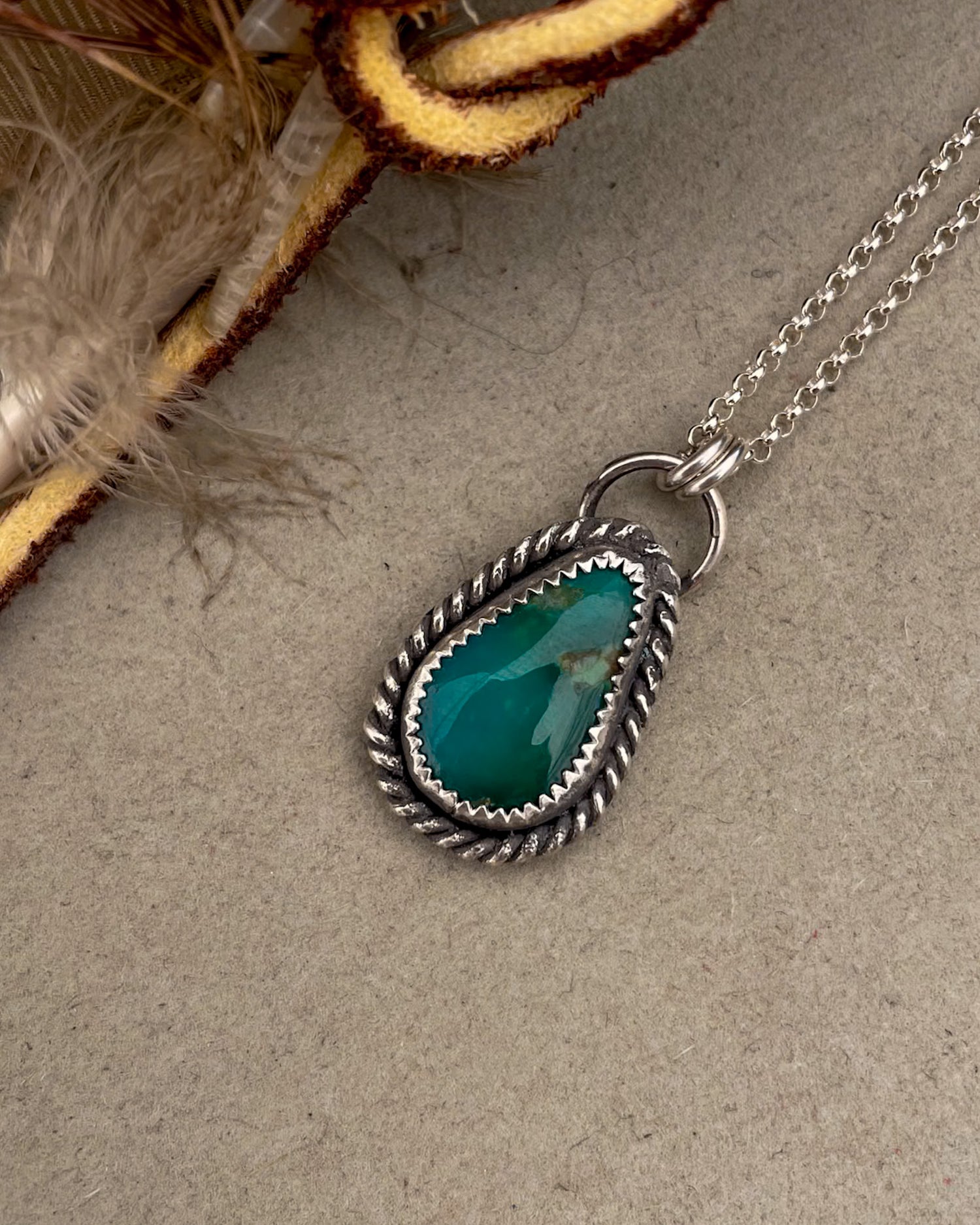 green turquoise teardrop pendant with twisted rope border on dainty rolo chain