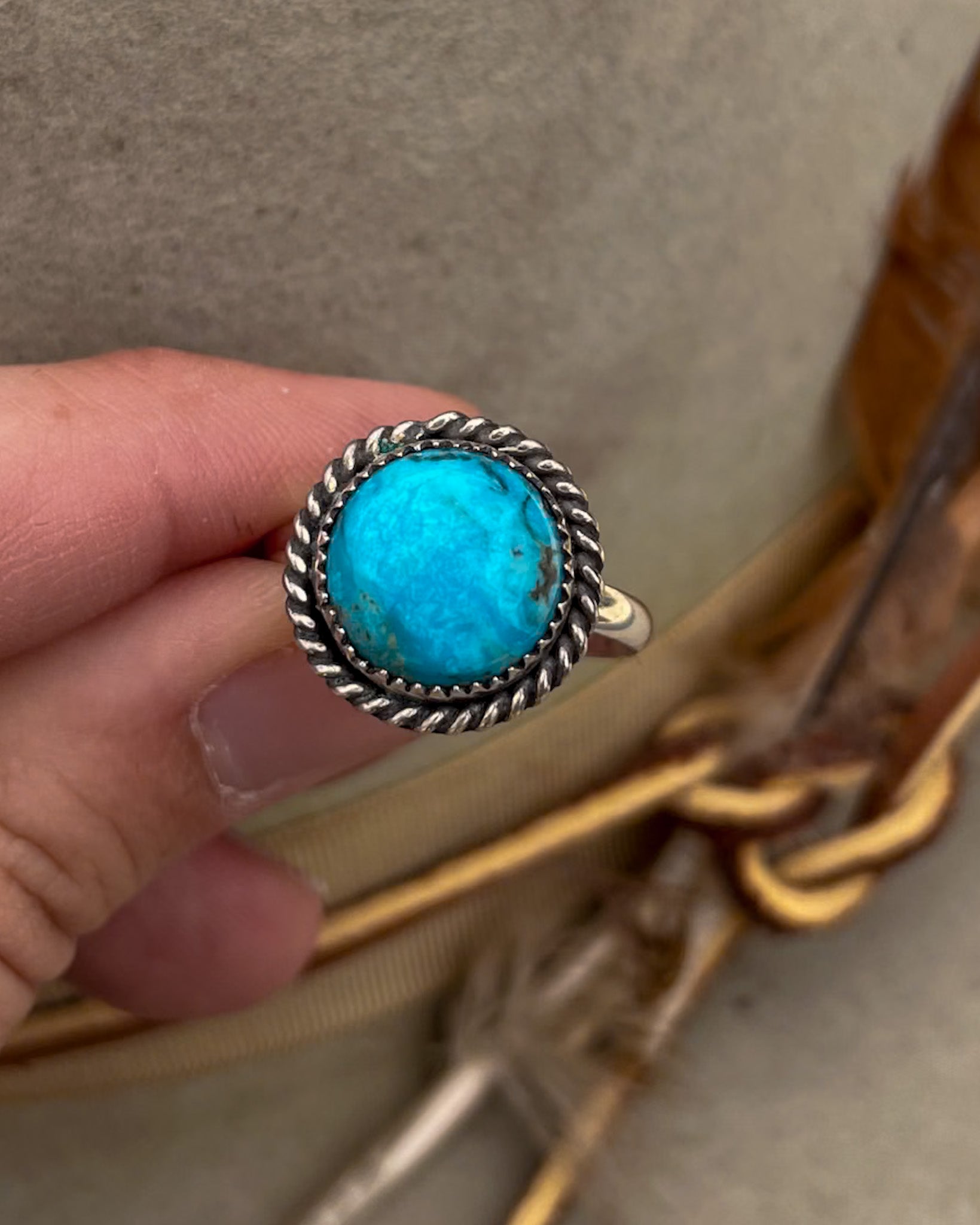 round kingman turquoise ring with twist rope border on silver halfround band