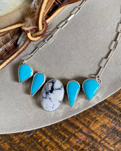 necklace with white buffalo center stone and two matching sleeping beauty stones mirrored on each side on paperclip chain