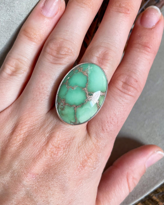 Large oval mint green turquoise ring on hand