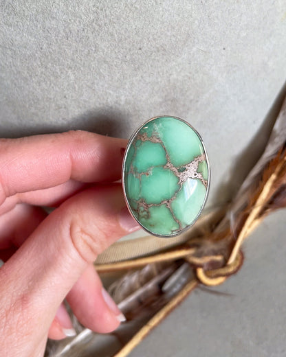 Hand holding Large oval mint green turquoise ring