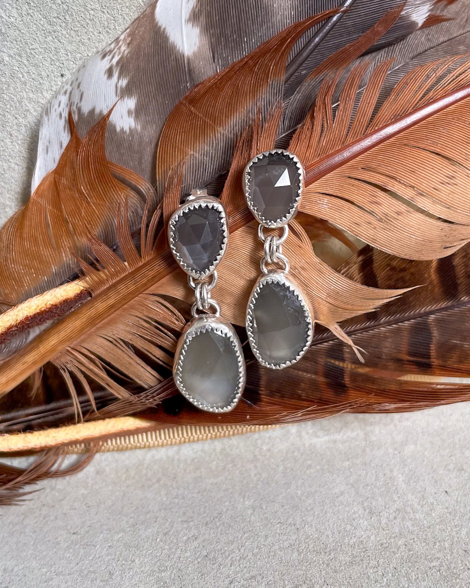 grey moonstone rosecut drop earrings on brown feather