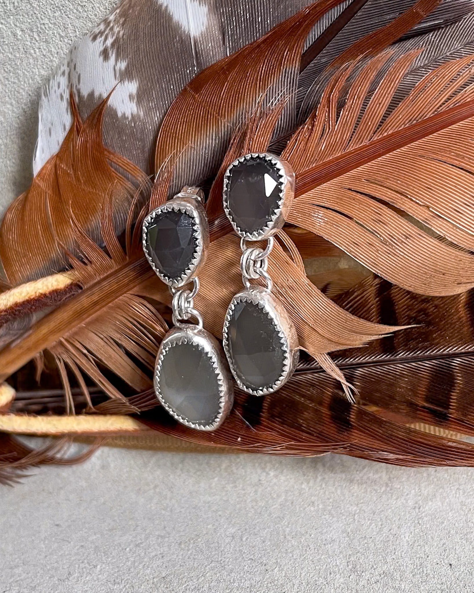 grey moonstone rosecut drop earrings on brown feather