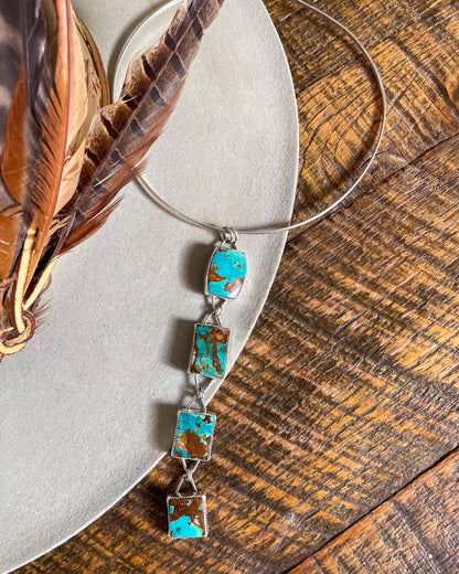 four stone pilot mountain turquoise pendant with rectangular stones connected in a row on silver collar necklace