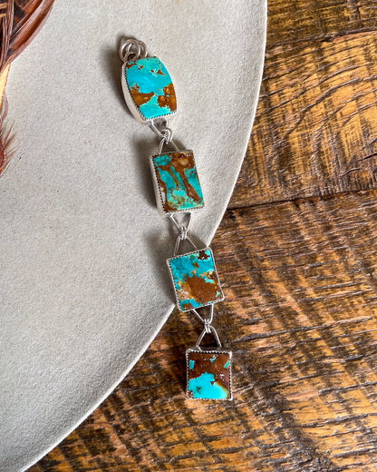 four stone pilot mountain turquoise pendant with rectangular stones connected in a row