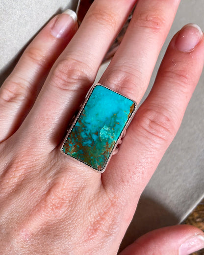 hand wearing blue and green ombre pilot mountain turquoise rectangular ring