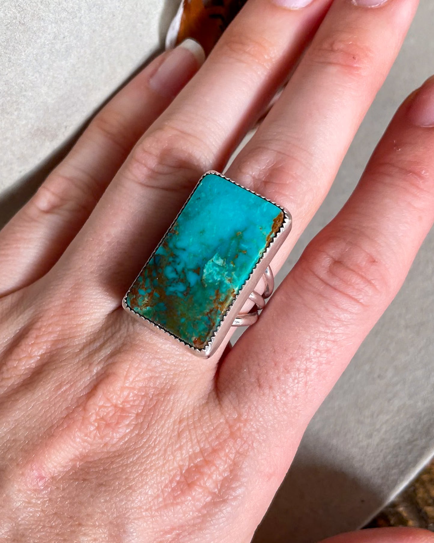hand wearing blue and green ombre pilot mountain turquoise rectangular ring