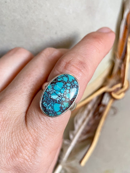 natural egyptian turquoise oval ring set in smooth bezel worn on hand