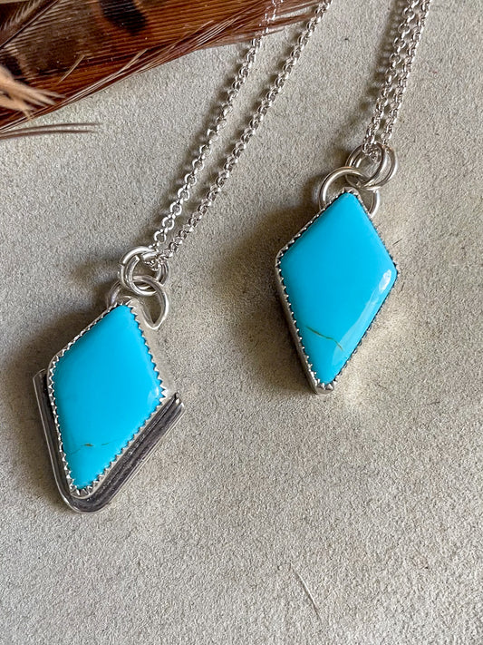 two diamond shaped sleeping beauty pendants on dainty rolo chains