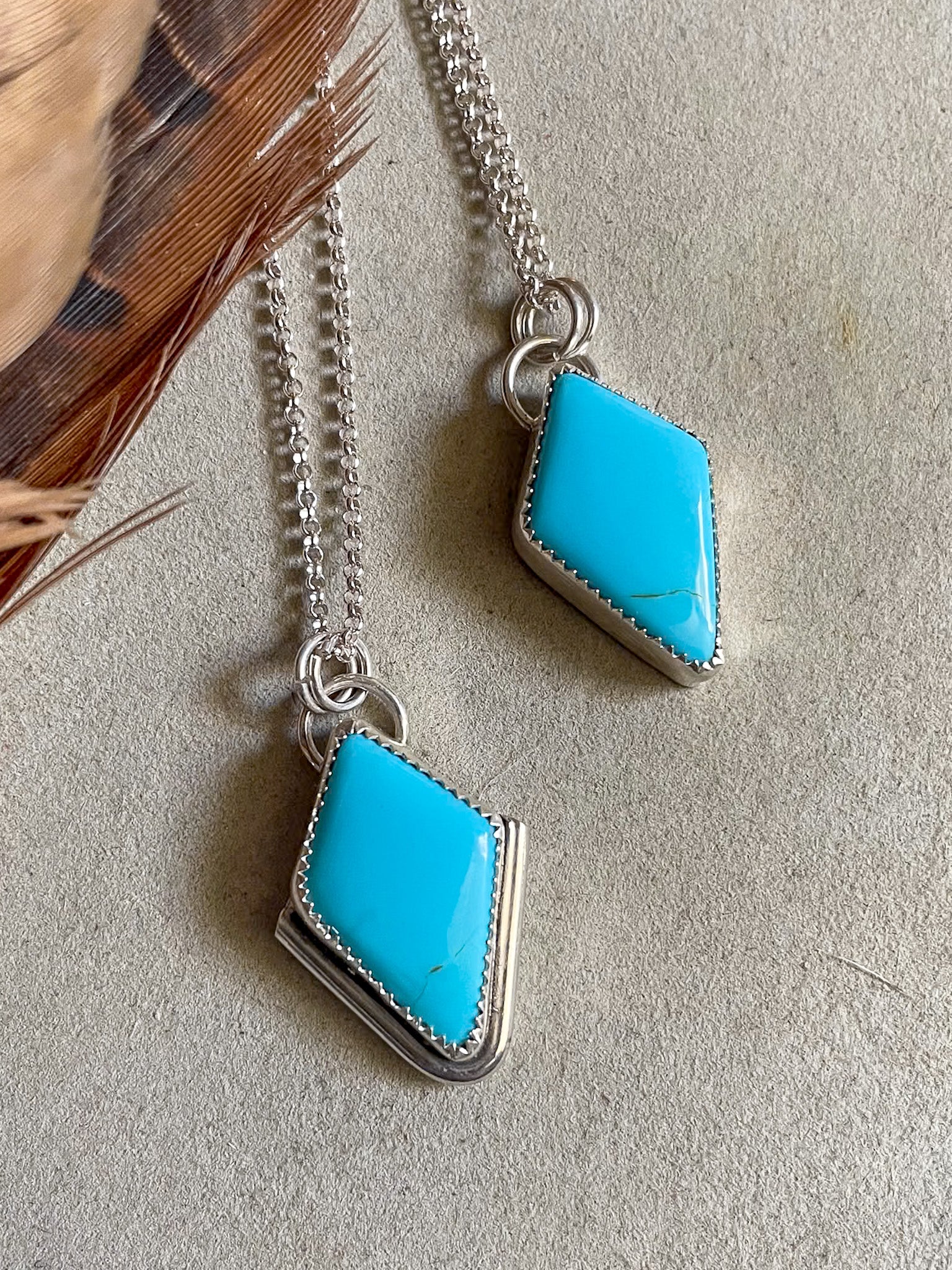 two diamond shaped sleeping beauty pendants on dainty rolo chains