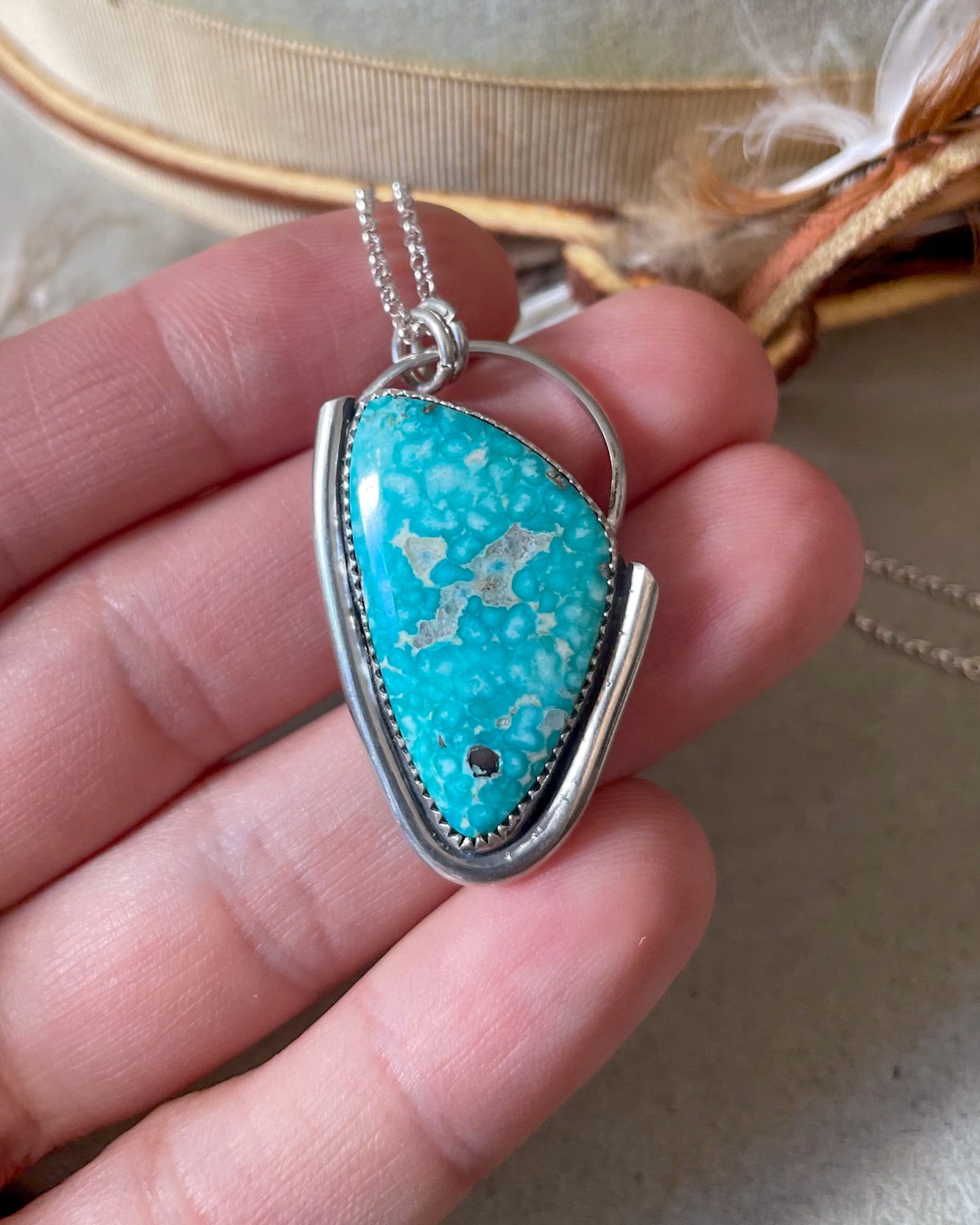 white water turquoise asymmetrical rogue necklace with silver border on oversized bail