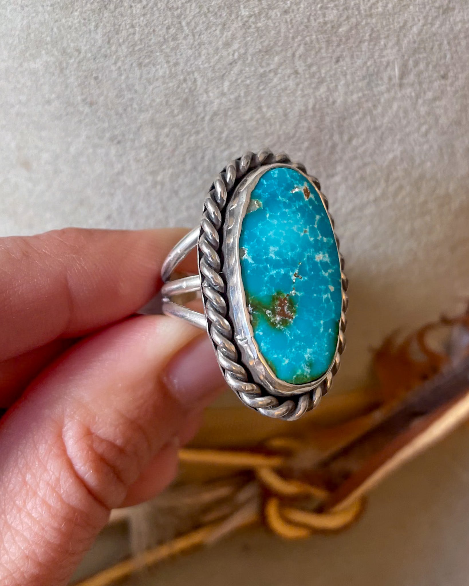 mexican mined turquoise blue with green oval ring in smooth bezeel with thick twist rope border on triple band