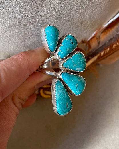 graduated white water turquoise half cluster ring on split shank band